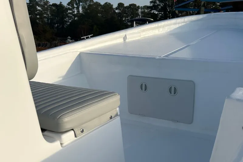 Slide: The Image of 2025 Panga Eduardono Panga 22 boat interior with gray seating and storage compartment. - 9