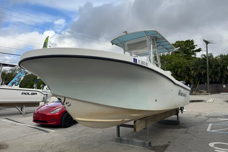 Slide: The Image of 2006 Dusky 278 boat on trailer, surrounded by lush greenery. - 1