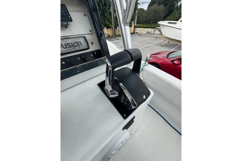 Slide: The Image of 2006 Dusky 278 boat console with canopy, surrounded by greenery and residential area. - 19