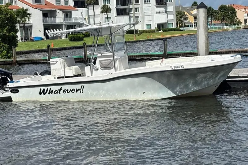 Slide: The Image of 2006 Dusky 278 boat interior with console, rod holders, and clean deck. - 2