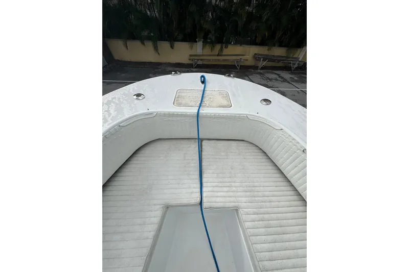 Slide: The Image of 2006 Dusky 278 boat interior with storage compartments and seating, dappled sunlight effect. - 23