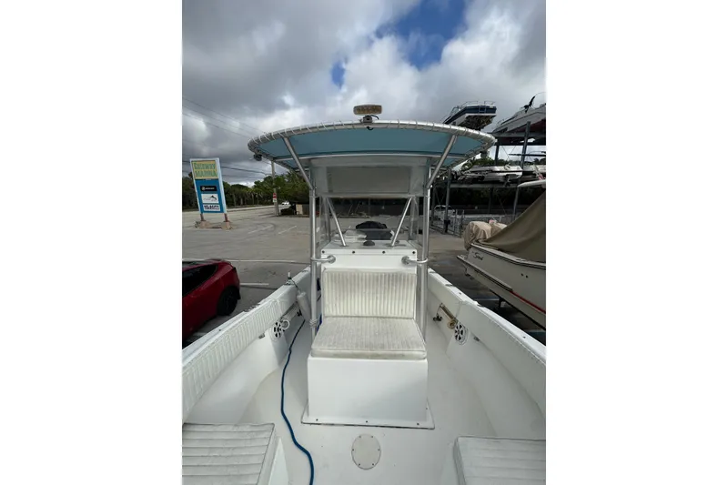 Slide: The Image of 2006 Dusky 278 boat interior with white seating and storage compartments. - 26