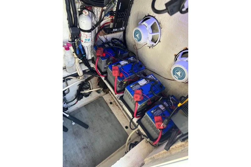 Slide: The Image of Open storage compartment on a 2006 Dusky 278 boat, containing a red life jacket. - 30