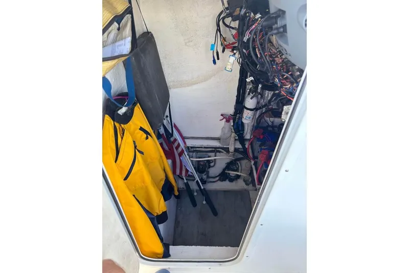 Slide: The Image of Open storage compartment on 2006 Dusky 278 boat, showing interior details and seating area. - 31