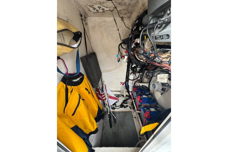 Slide: The Image of Open storage compartment on a 2006 Dusky 278 boat with colorful items inside. - 32