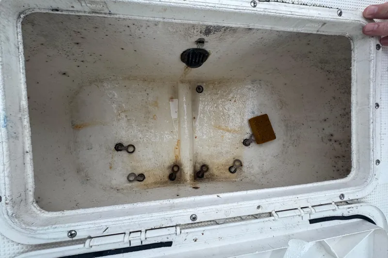 Slide: The Image of 2006 Dusky 278 boat with spacious deck, surrounded by lush greenery. - 38