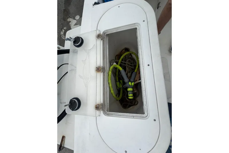 Slide: The Image of 2006 Dusky 278 boat with center console, surrounded by lush greenery and a serene waterfront. - 41