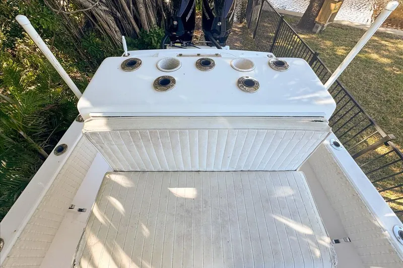 Slide: The Image of 2006 Dusky 278 boat interior with white seating and rod holders. - 46