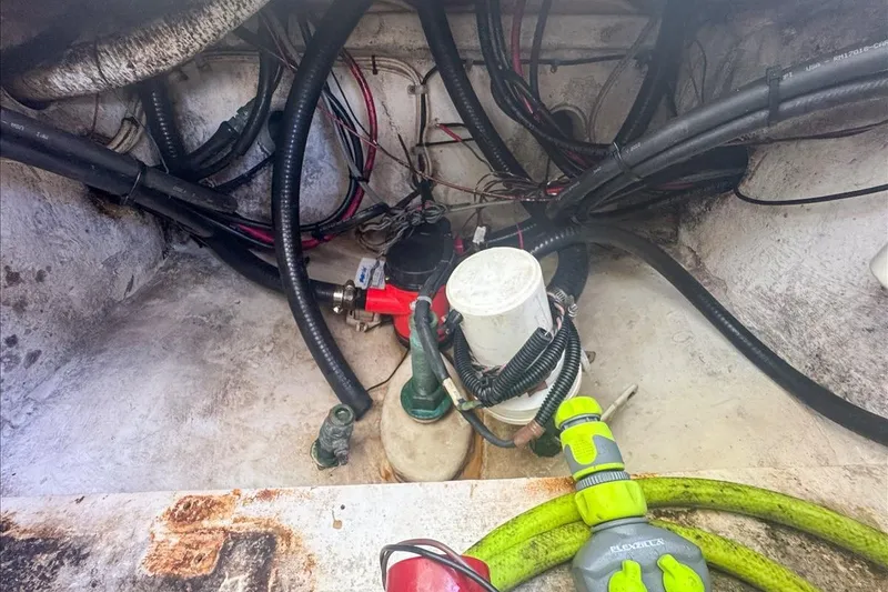 Slide: The Image of Bilge area of a 2006 Dusky 278 boat with hoses and wiring. - 56
