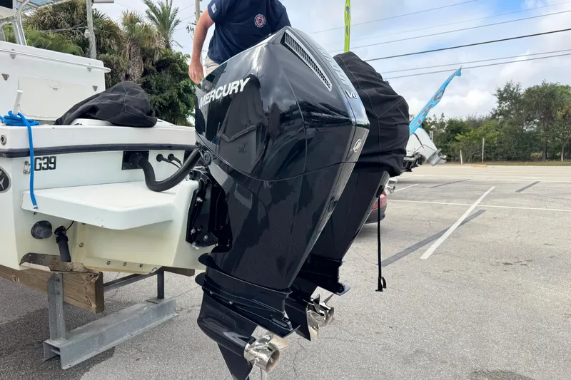 Slide: The Image of 2006 Dusky 278 boat with T-top and console, surrounded by tropical foliage. - 8
