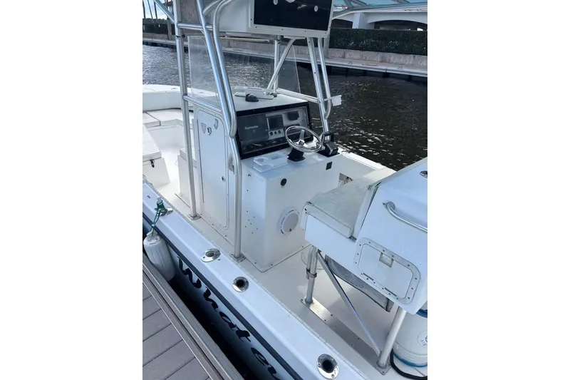 Slide: The Image of 2006 Dusky 278 boat interior with storage compartment, surrounded by tropical plants. - 10