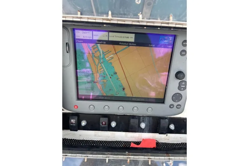 Slide: The Image of 2006 Dusky 278 boat interior with white seating and storage compartments. - 21