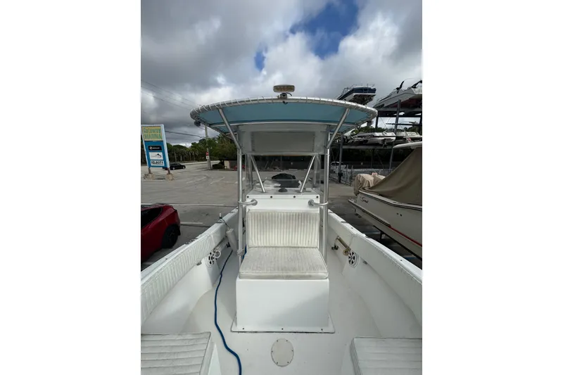 Slide: The Image of 2006 Dusky 278 boat interior with white seating and storage compartments. - 22