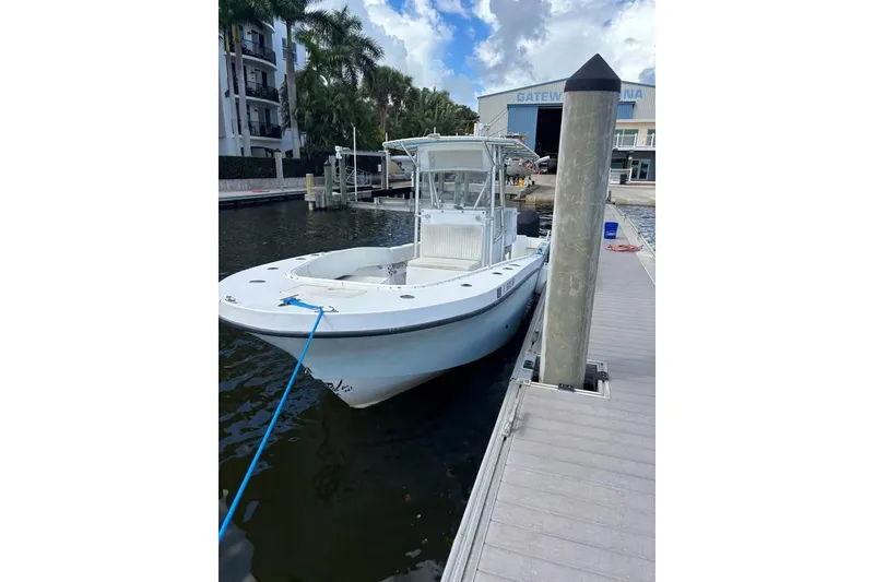 Slide: The Image of 2006 Dusky 278 boat interior, featuring a clean, spacious deck with storage compartments. - 3