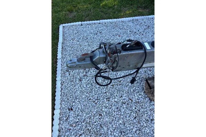 Slide: The Image of 2006 Dusky 278 boat interior with white deck and storage compartments. - 39