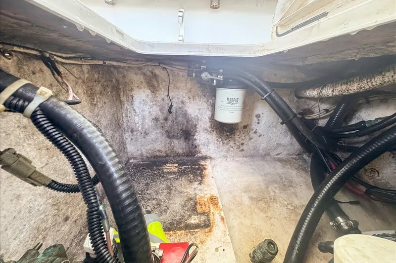 Slide: The Image of 2006 Dusky 278 boat engine compartment with visible wiring and filter. - 57