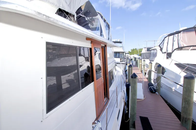 Slide: The Image of 1985 Gulfstar 44 Motor Yacht docked at marina under clear blue sky. - 12
