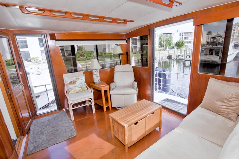 Slide: The Image of Interior of 1985 Gulfstar 44 Motor Yacht with cozy seating and waterfront view. - 22