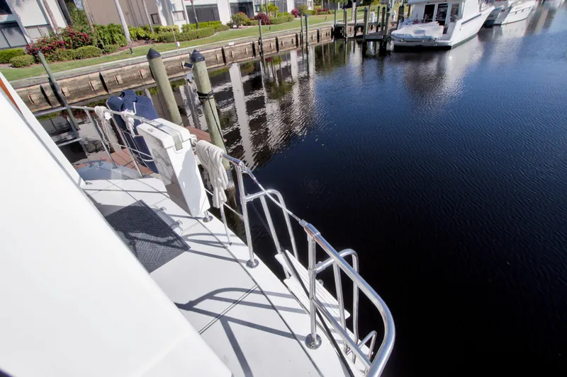 Slide: The Image of 1985 Gulfstar 44 Motor Yacht docked at marina, calm water reflection. - 23