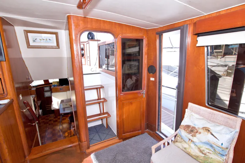 Slide: The Image of Interior of 1985 Gulfstar 44 Motor Yacht with wooden finishes and nautical decor. - 28