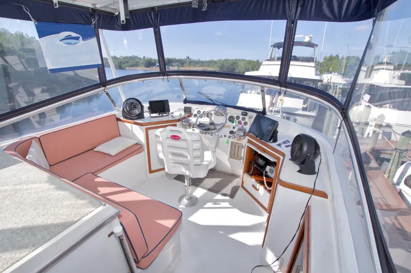 Slide: The Image of 1985 Gulfstar 44 Motor Yacht helm with seating, navigation equipment, and panoramic views. - 29