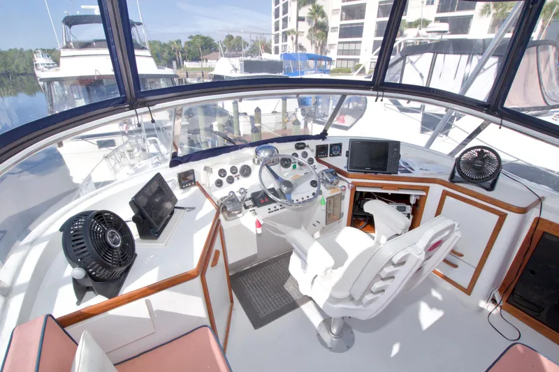 Slide: The Image of 1985 Gulfstar 44 Motor Yacht helm with modern navigation equipment and comfortable seating. - 30
