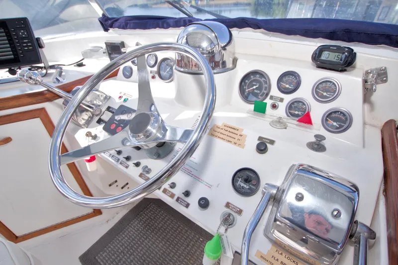 Slide: The Image of Helm of 1985 Gulfstar 44 Motor Yacht with steering wheel and control gauges. - 33