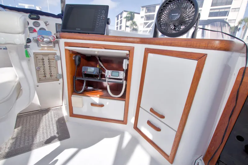 Slide: The Image of 1985 Gulfstar 44 Motor Yacht helm with navigation equipment and storage cabinets. - 34