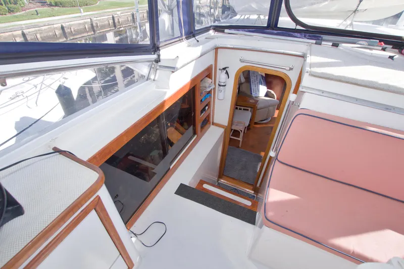 Slide: The Image of 1985 Gulfstar 44 Motor Yacht interior view with seating and cabin entrance. - 36