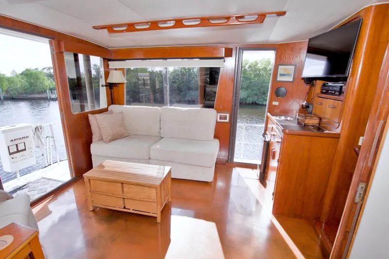 Slide: The Image of Interior of 1985 Gulfstar 44 Motor Yacht with sofa, wooden decor, and river view. - 38