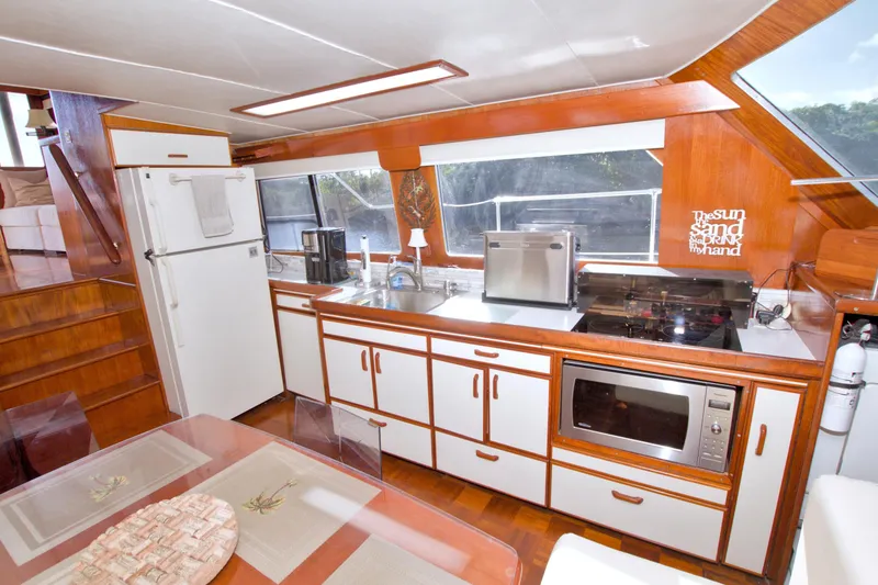 Slide: The Image of 1985 Gulfstar 44 Motor Yacht kitchen with modern appliances and wooden cabinetry. - 42