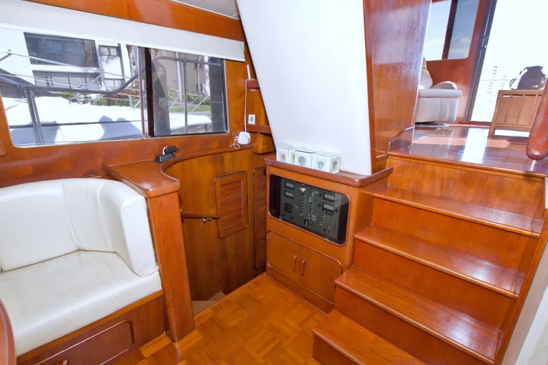 Slide: The Image of Interior of 1985 Gulfstar 44 Motor Yacht with wooden stairs and seating area. - 44