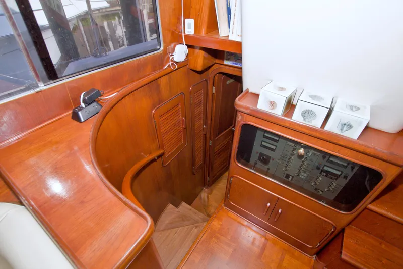 Slide: The Image of 1985 Gulfstar 44 Motor Yacht interior with wooden cabinetry and staircase. - 46