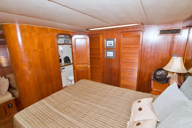 Slide: The Image of Cozy bedroom in 1985 Gulfstar 44 Motor Yacht with wood paneling and ensuite bathroom. - 51