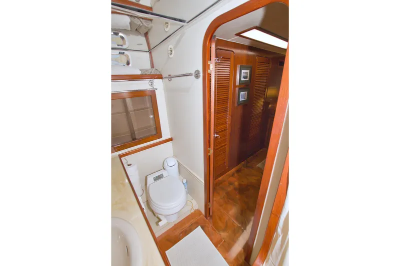 Slide: The Image of 1985 Gulfstar 44 Motor Yacht bathroom with wooden accents and modern amenities. - 53