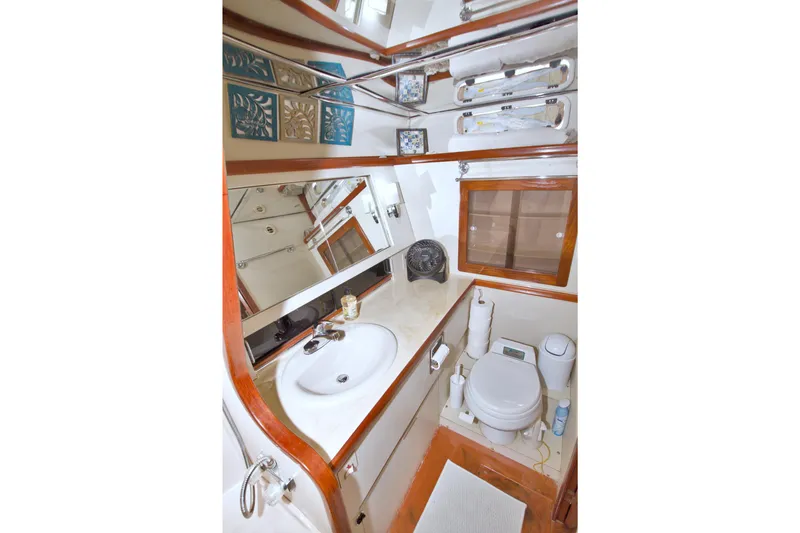 Slide: The Image of Bathroom interior of 1985 Gulfstar 44 Motor Yacht with sink, toilet, and mirror. - 54