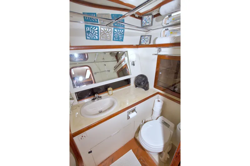 Slide: The Image of 1985 Gulfstar 44 Motor Yacht bathroom with sink, mirror, and toilet. - 55