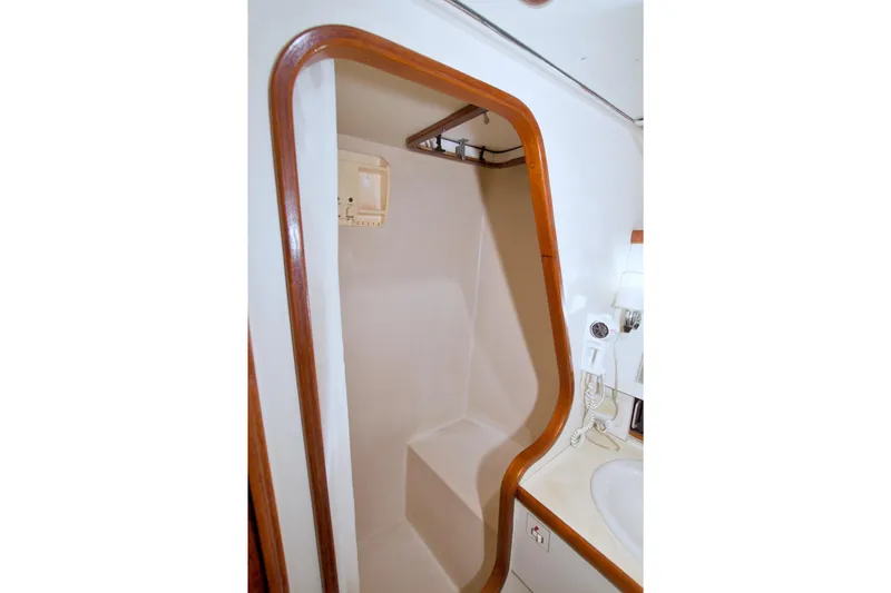 Slide: The Image of Shower area in 1985 Gulfstar 44 Motor Yacht with wooden trim and built-in seat. - 57