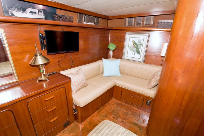 Slide: The Image of Interior of 1985 Gulfstar 44 Motor Yacht with cozy seating and wooden decor. - 58
