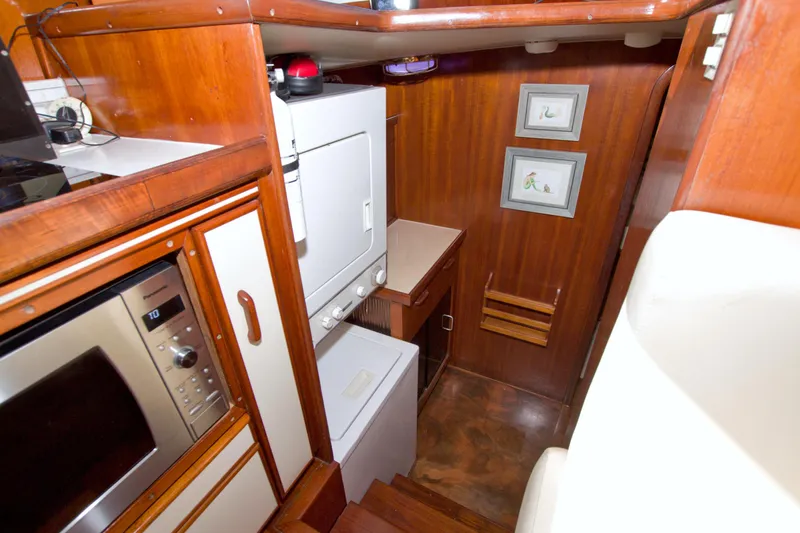 Slide: The Image of Interior of 1985 Gulfstar 44 Motor Yacht with wood paneling and appliances. - 62