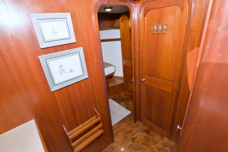Slide: The Image of Interior of 1985 Gulfstar 44 Motor Yacht with wooden paneling and framed artwork. - 65