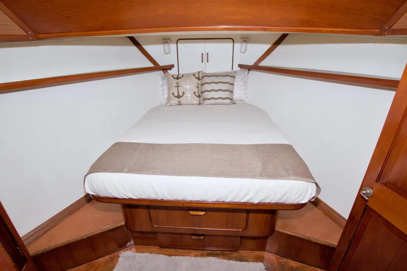 Slide: The Image of 1985 Gulfstar 44 Motor Yacht bedroom with cozy bed and nautical decor. - 66