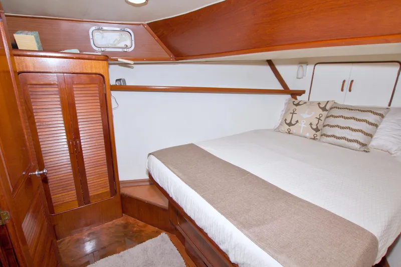 Slide: The Image of Cozy bedroom in 1985 Gulfstar 44 Motor Yacht with wood accents and nautical decor. - 67