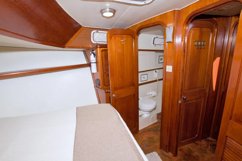 Slide: The Image of Interior of 1985 Gulfstar 44 Motor Yacht with wooden cabinetry and compact bathroom. - 70