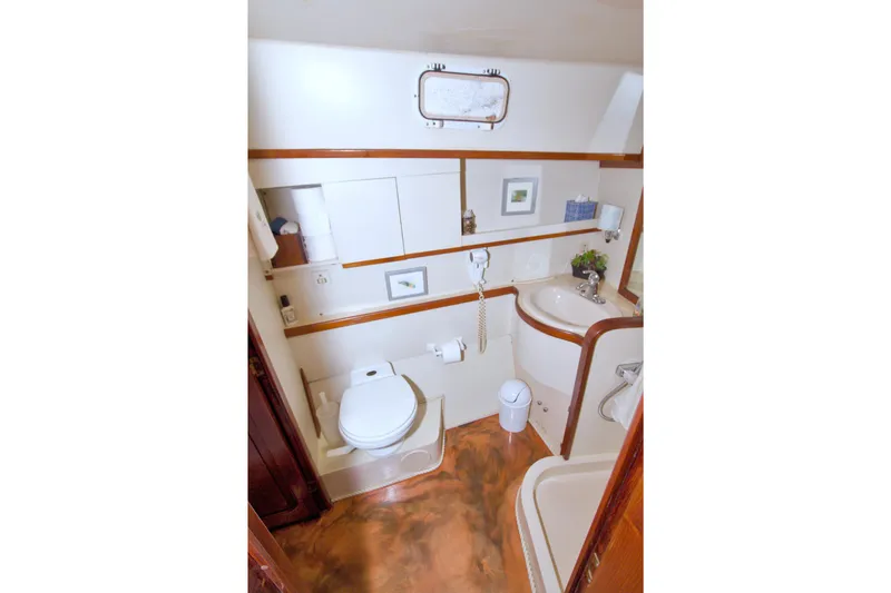 Slide: The Image of Bathroom interior of 1985 Gulfstar 44 Motor Yacht with sink, toilet, and storage. - 72
