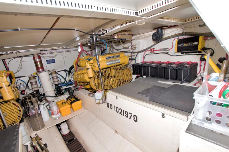 Slide: The Image of Engine room of 1985 Gulfstar 44 Motor Yacht with Caterpillar engines and battery setup. - 77