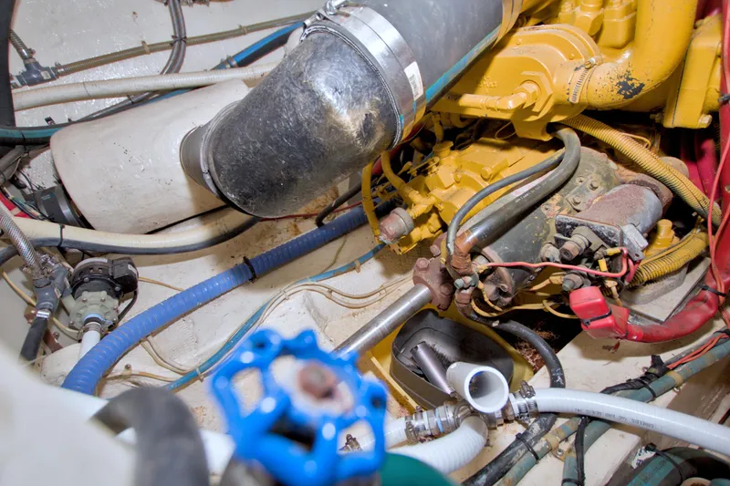 Slide: The Image of Engine room of 1985 Gulfstar 44 Motor Yacht with visible pipes and machinery. - 83