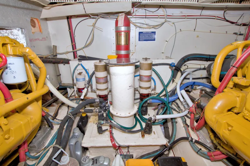 Slide: The Image of Engine room of a 1985 Gulfstar 44 Motor Yacht with visible machinery and wiring. - 86