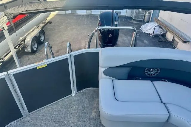 Slide: The Image of 2026 Barletta A20L pontoon boat interior with seating and motor view. - 9
