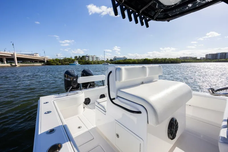 Slide: The Image of 2019 SeaHunter 28 Floridian boat interior with dual engines on a sunny day. - 12